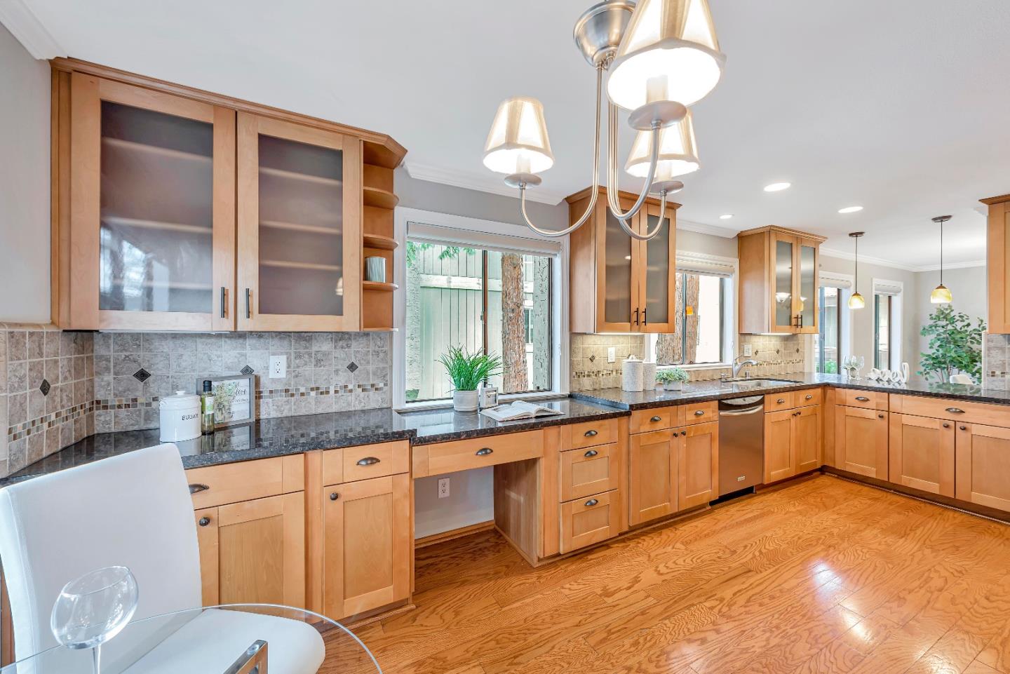 47 Dot Avenue, Unit A Campbell, CA 95008 - Photo 15 of 31 a large kitchen with granite countertop a stove a sink dishwasher a dining table and chairs with wooden floor