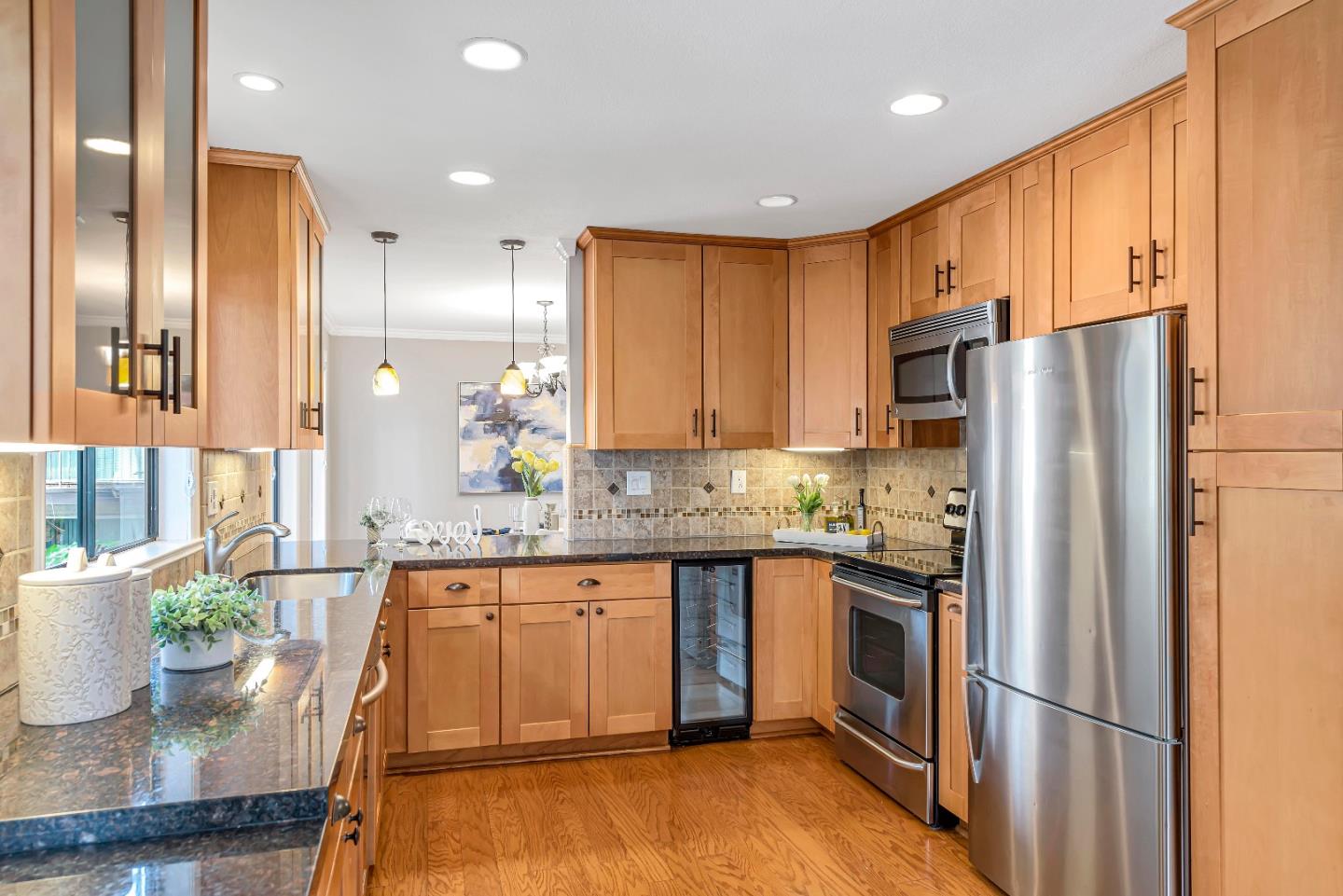 47 Dot Avenue, Unit A Campbell, CA 95008 - Photo 16 of 31 a kitchen with stainless steel appliances granite countertop a refrigerator a sink dishwasher and wooden cabinets with wooden floor