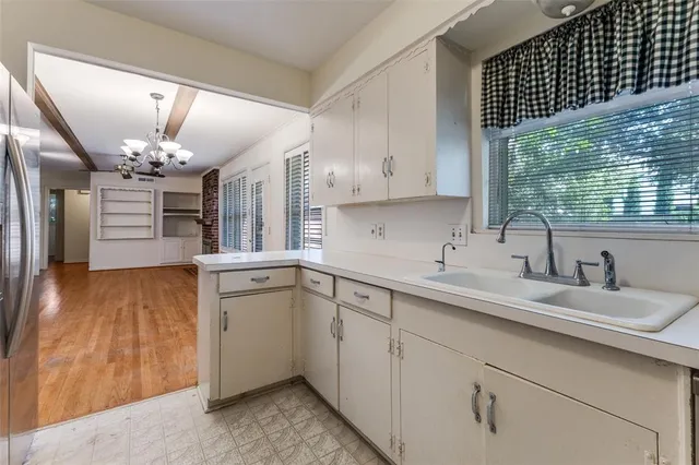 a kitchen with a sink cabinets and window