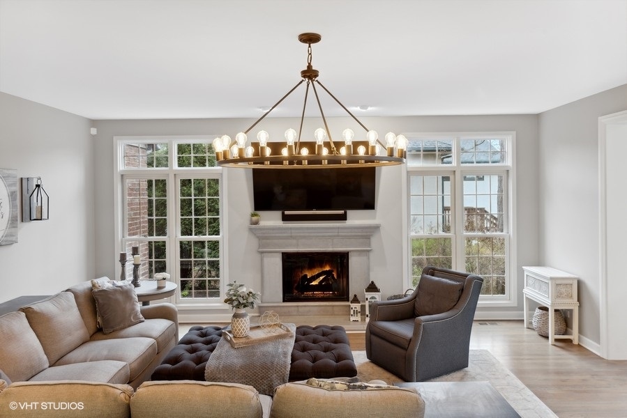 134 West 59th Street Burr Ridge, IL 60527 - Photo 12 of 41 a living room with furniture a large window and a fireplace