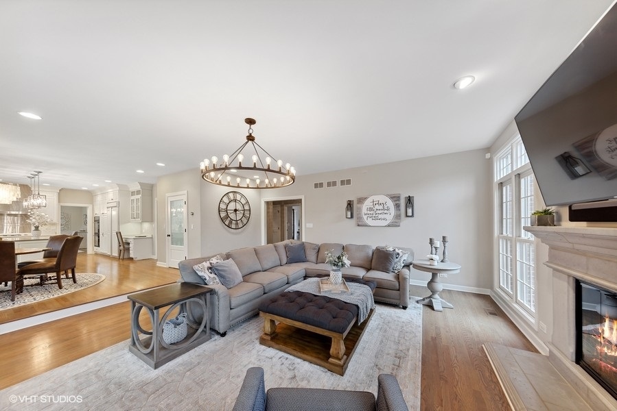 134 West 59th Street Burr Ridge, IL 60527 - Photo 13 of 41 a living room with furniture a fireplace and a flat screen tv
