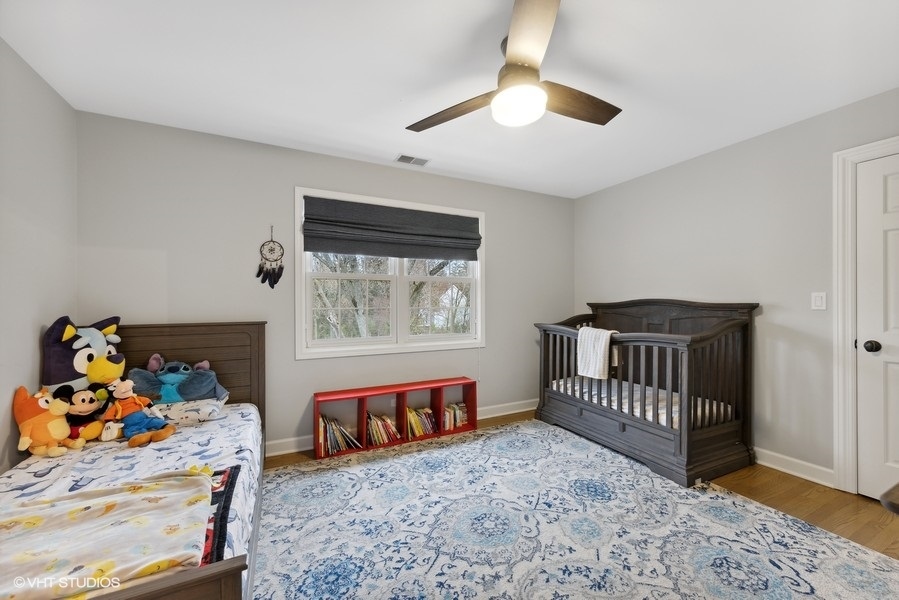 134 West 59th Street Burr Ridge, IL 60527 - Photo 22 of 41 a bedroom with furniture and a baby crib