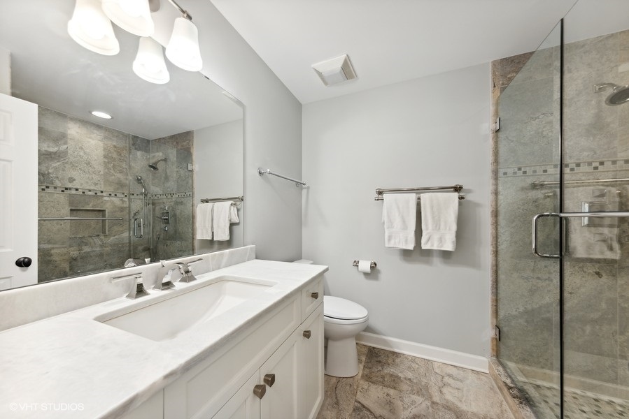 134 West 59th Street Burr Ridge, IL 60527 - Photo 24 of 41 a bathroom with a sink a toilet and shower