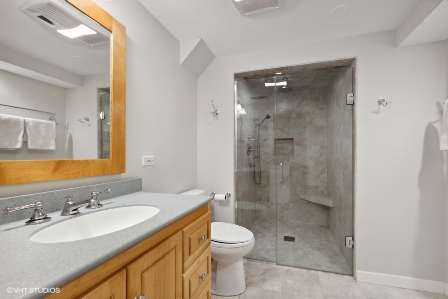 134 West 59th Street Burr Ridge, IL 60527 - Photo 32 of 41 a bathroom with a granite countertop sink toilet mirror and shower