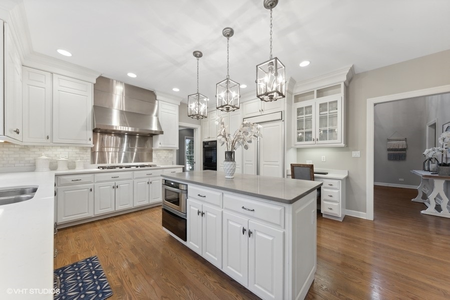 134 West 59th Street Burr Ridge, IL 60527 - Photo 9 of 41 a open kitchen with stainless steel appliances granite countertop a sink dishwasher a stove a dining table and chairs with wooden floor