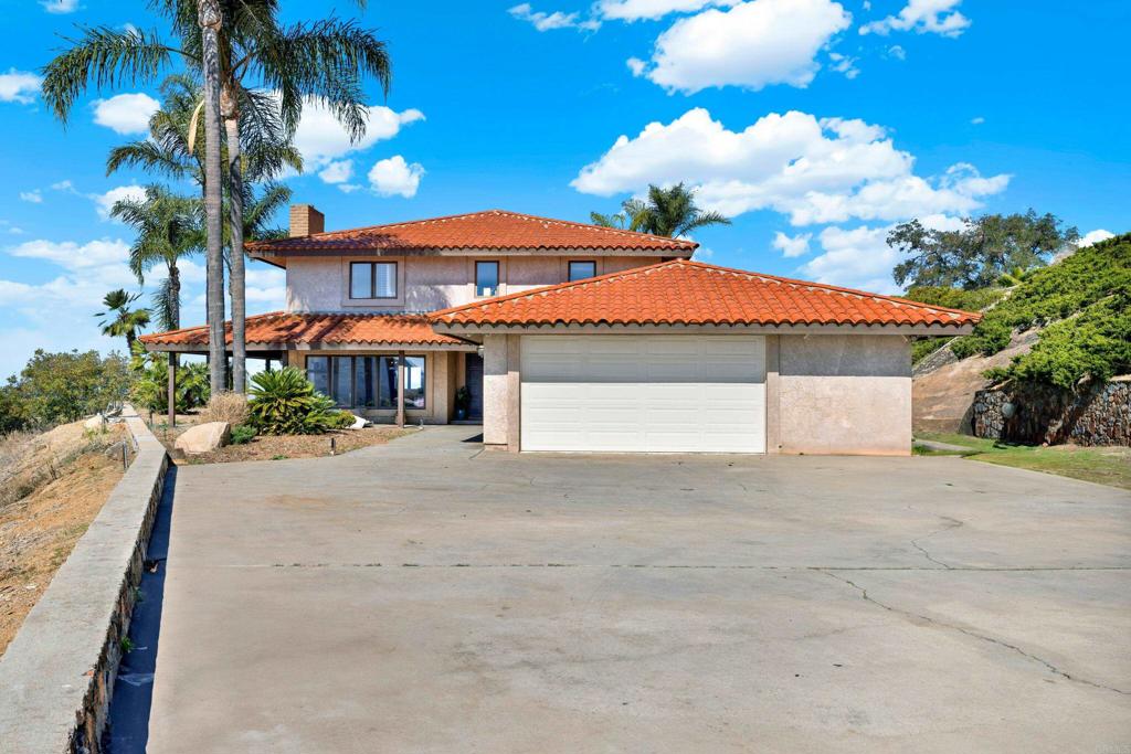 29345 Wilkes Road Valley Center, CA 92082 - Photo 18 of 63 a front view of a house with a yard and a garage