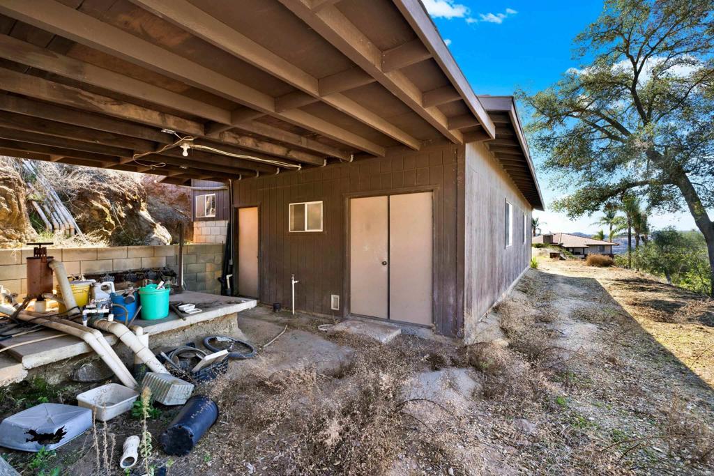 29345 Wilkes Road Valley Center, CA 92082 - Photo 30 of 63 a view of patio with a table and chairs under an umbrella with a small yard