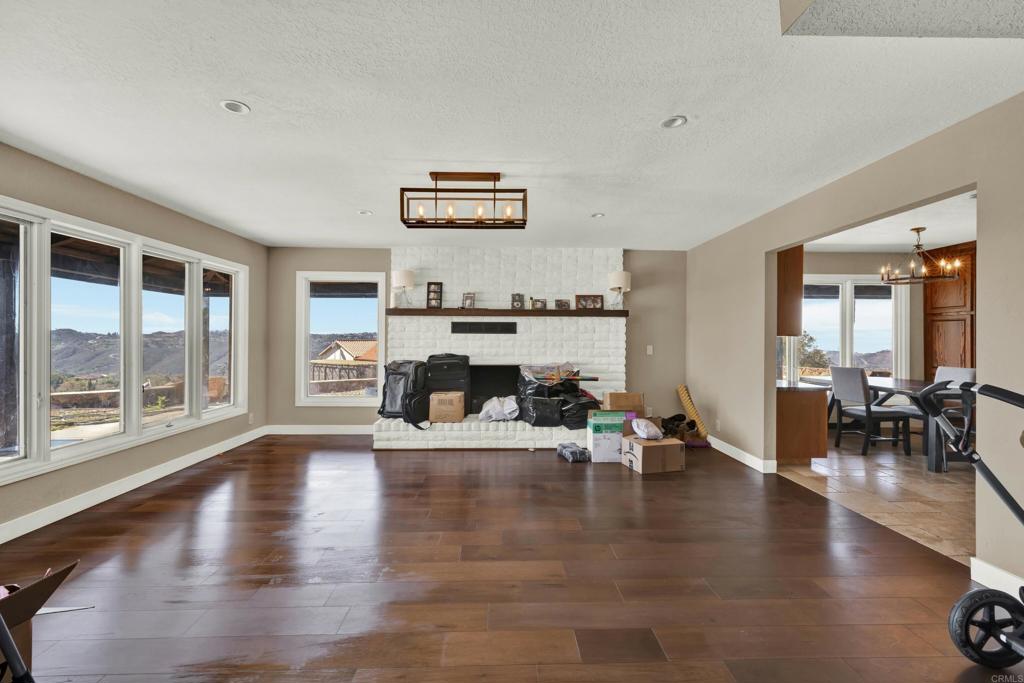 29345 Wilkes Road Valley Center, CA 92082 - Photo 36 of 63 a living room with fireplace furniture and a large window