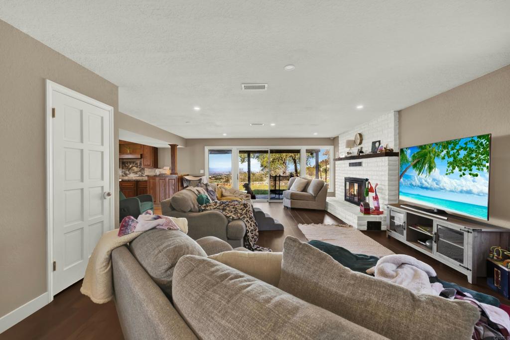 29345 Wilkes Road Valley Center, CA 92082 - Photo 38 of 63 a living room with furniture and a flat screen tv