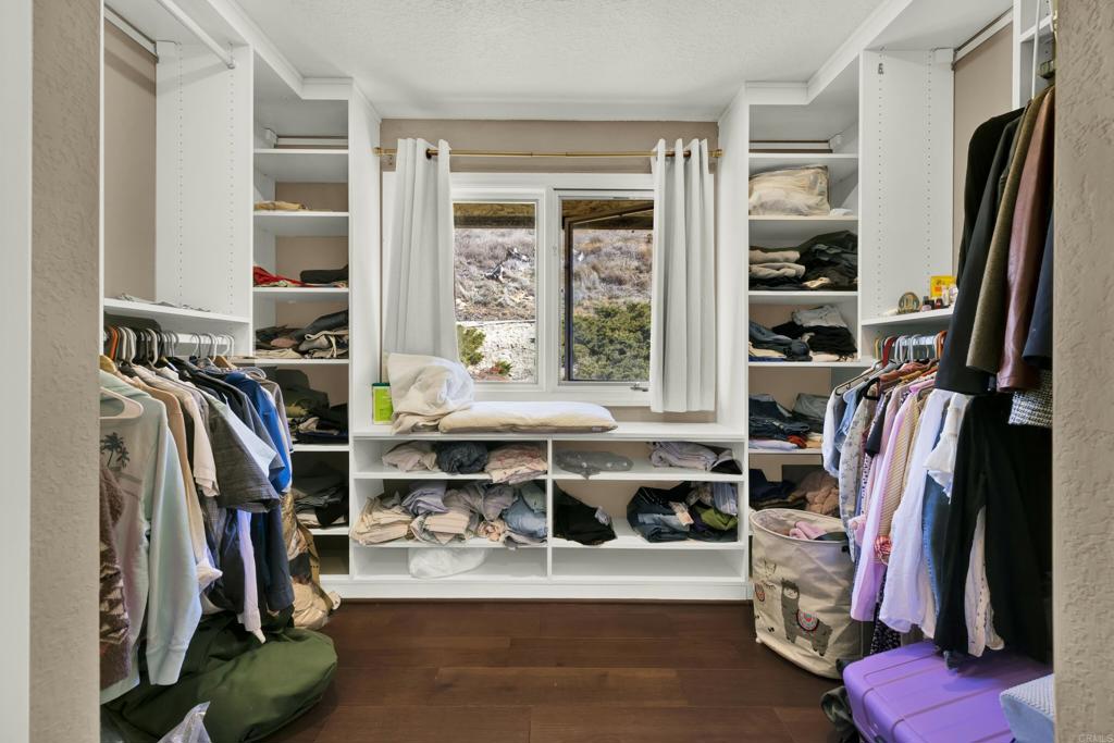 29345 Wilkes Road Valley Center, CA 92082 - Photo 43 of 63 a view of walk in closet with clothes and shoes