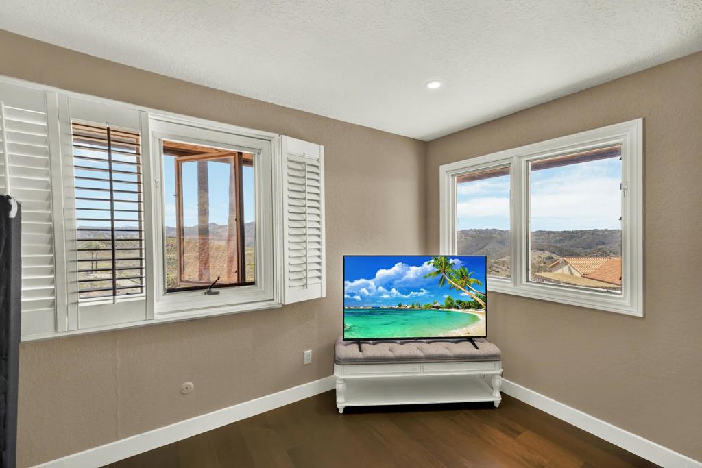 29345 Wilkes Road Valley Center, CA 92082 - Photo 50 of 63 a living room with furniture and a flat screen tv