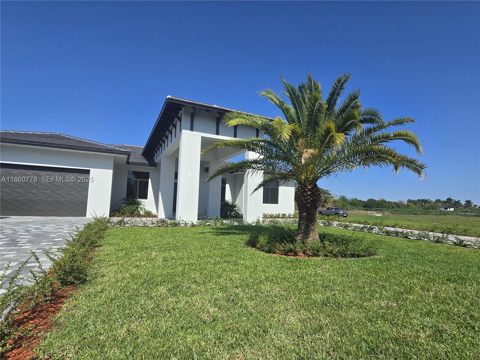 23840 Southwest 209th Place Homestead, FL 33031 - Photo 11 of 89 a front view of a house with a garden