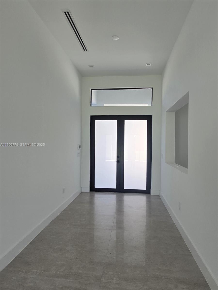 23840 Southwest 209th Place Homestead, FL 33031 - Photo 24 of 89 a view of an empty room with a window and wooden floor