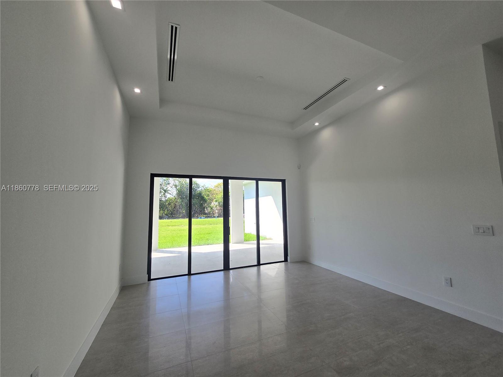 23840 Southwest 209th Place Homestead, FL 33031 - Photo 27 of 89 an empty room with large windows and mountain view