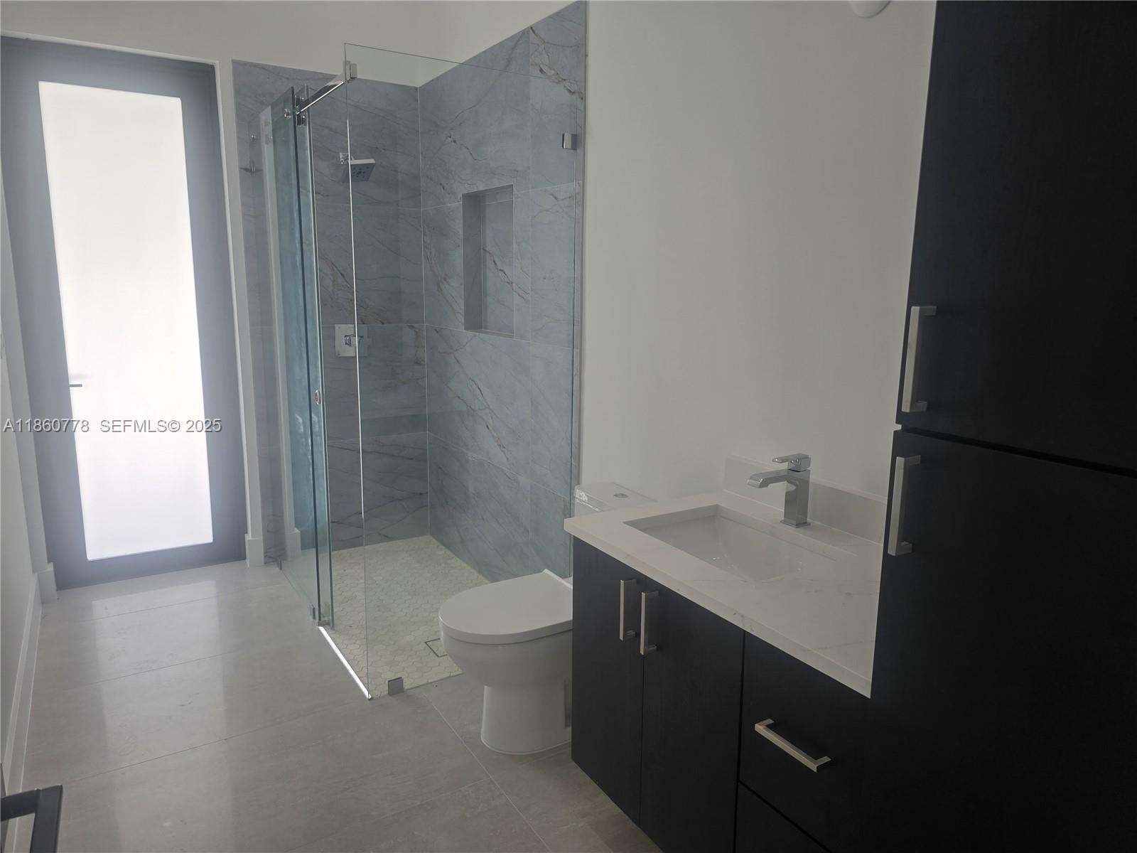 23840 Southwest 209th Place Homestead, FL 33031 - Photo 31 of 89 a bathroom with a sink toilet and shower