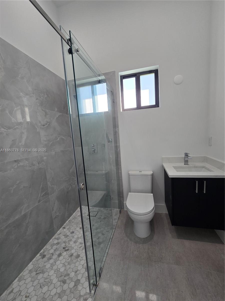 23840 Southwest 209th Place Homestead, FL 33031 - Photo 33 of 89 a bathroom with a sink a toilet and shower