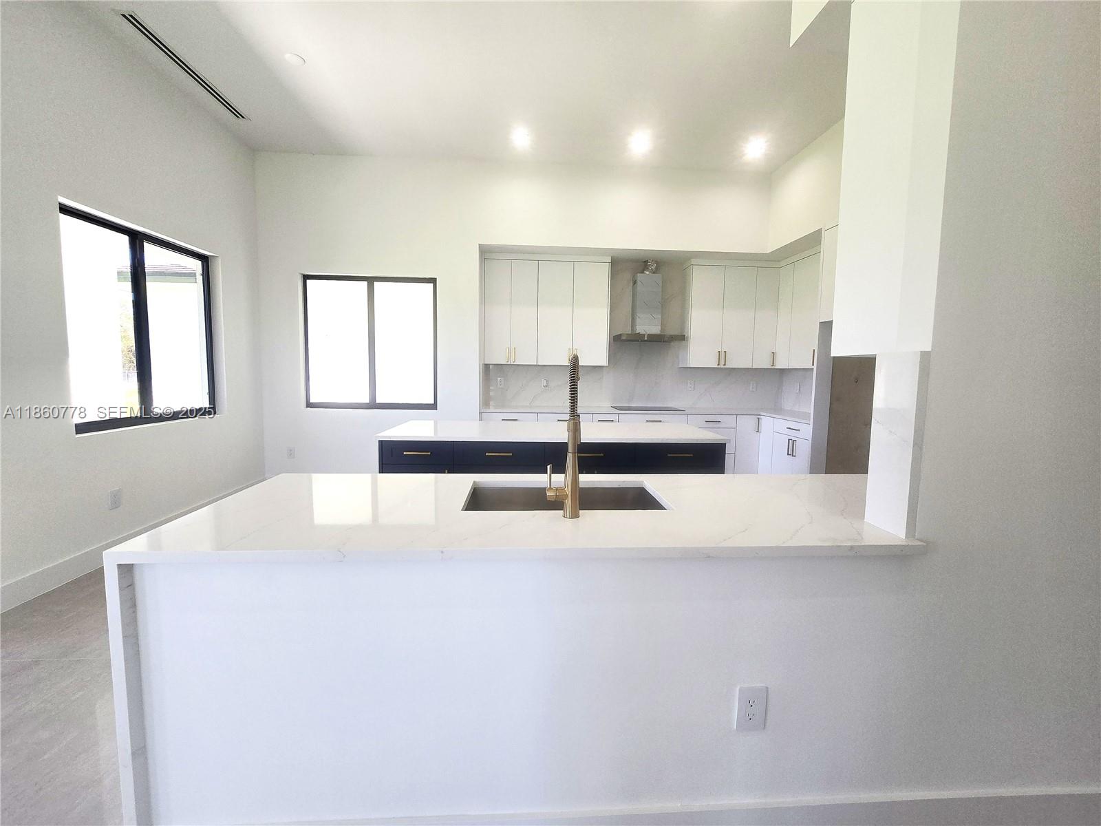 23840 Southwest 209th Place Homestead, FL 33031 - Photo 37 of 89 a kitchen with a sink a window and cabinets