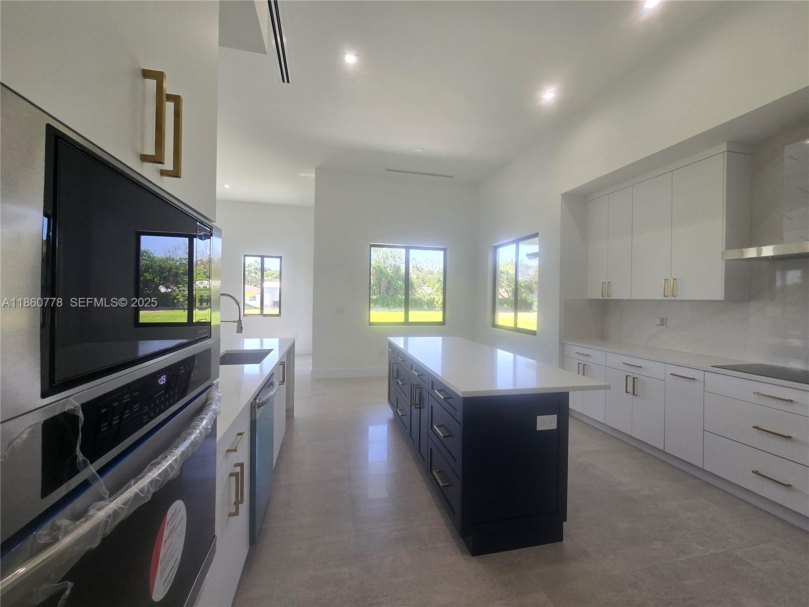 23840 Southwest 209th Place Homestead, FL 33031 - Photo 42 of 89 a kitchen with granite countertop a stove top oven a sink dishwasher and a refrigerator