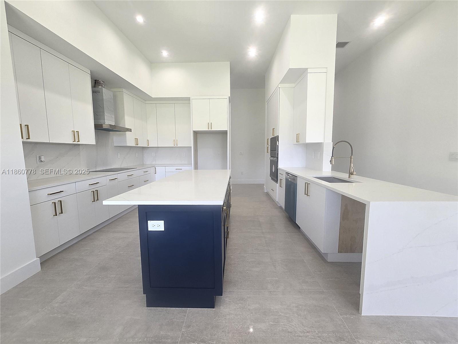 23840 Southwest 209th Place Homestead, FL 33031 - Photo 45 of 89 a large kitchen with kitchen island a sink stainless steel appliances and cabinets