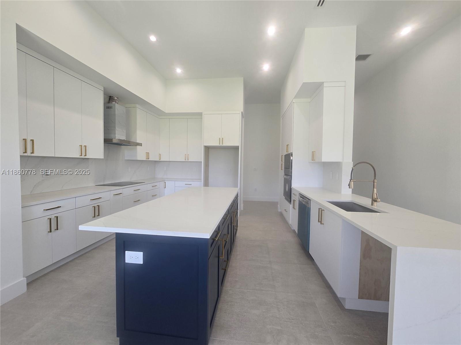 23840 Southwest 209th Place Homestead, FL 33031 - Photo 46 of 89 a large kitchen with stainless steel appliances sink a microwave and cabinets