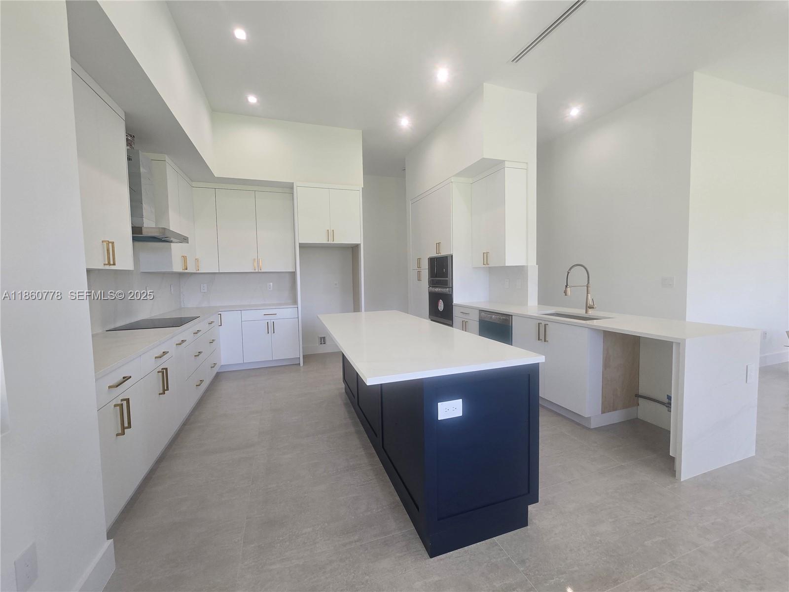 23840 Southwest 209th Place Homestead, FL 33031 - Photo 49 of 89 a large kitchen with stainless steel appliances a sink stove and cabinets