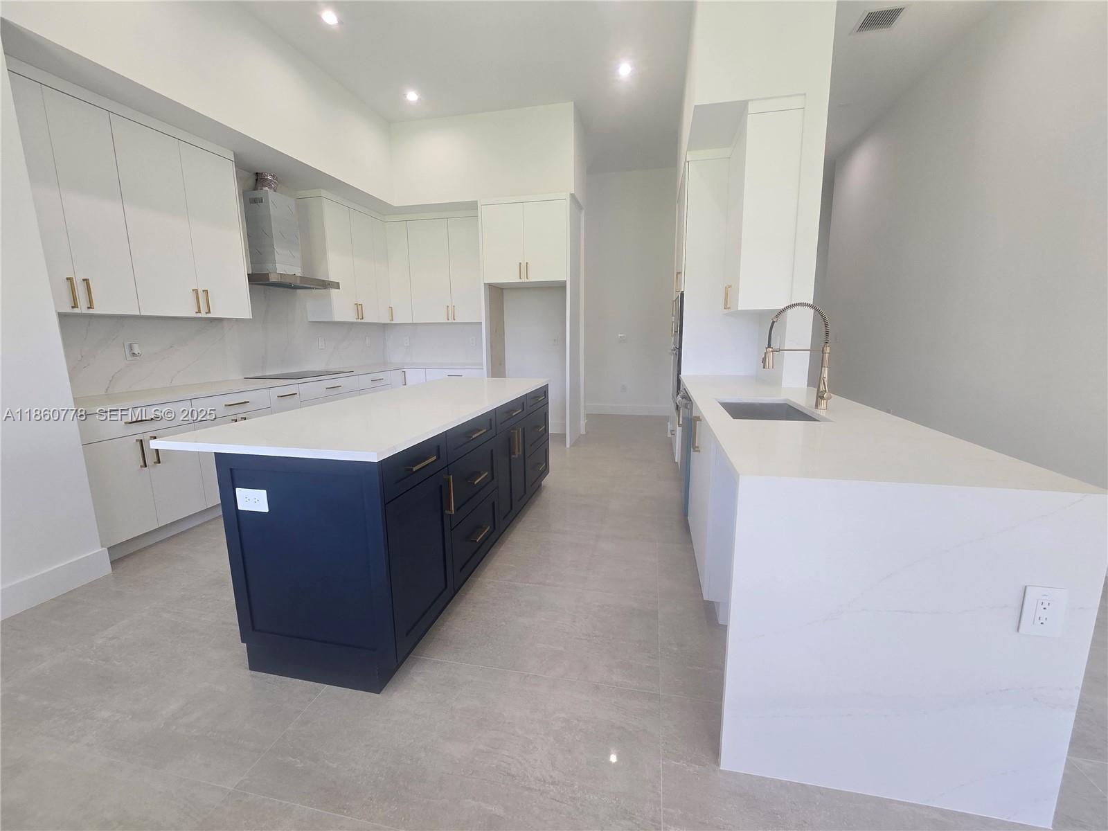 23840 Southwest 209th Place Homestead, FL 33031 - Photo 50 of 89 a kitchen with a sink a stove a refrigerator and a oven