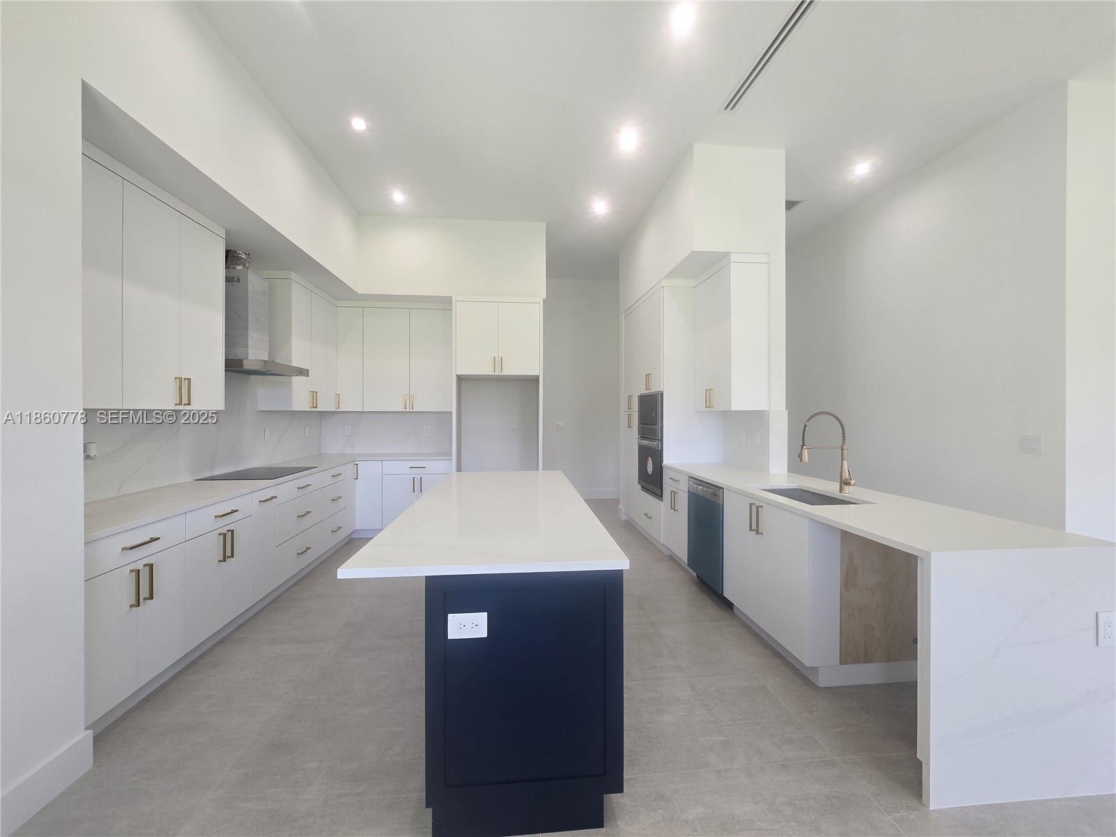 23840 Southwest 209th Place Homestead, FL 33031 - Photo 52 of 89 a large kitchen with stainless steel appliances kitchen island a sink a stove a refrigerator and white cabinets