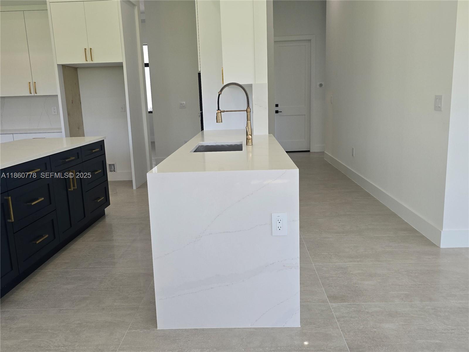 23840 Southwest 209th Place Homestead, FL 33031 - Photo 57 of 89 a kitchen with a sink and a refrigerator