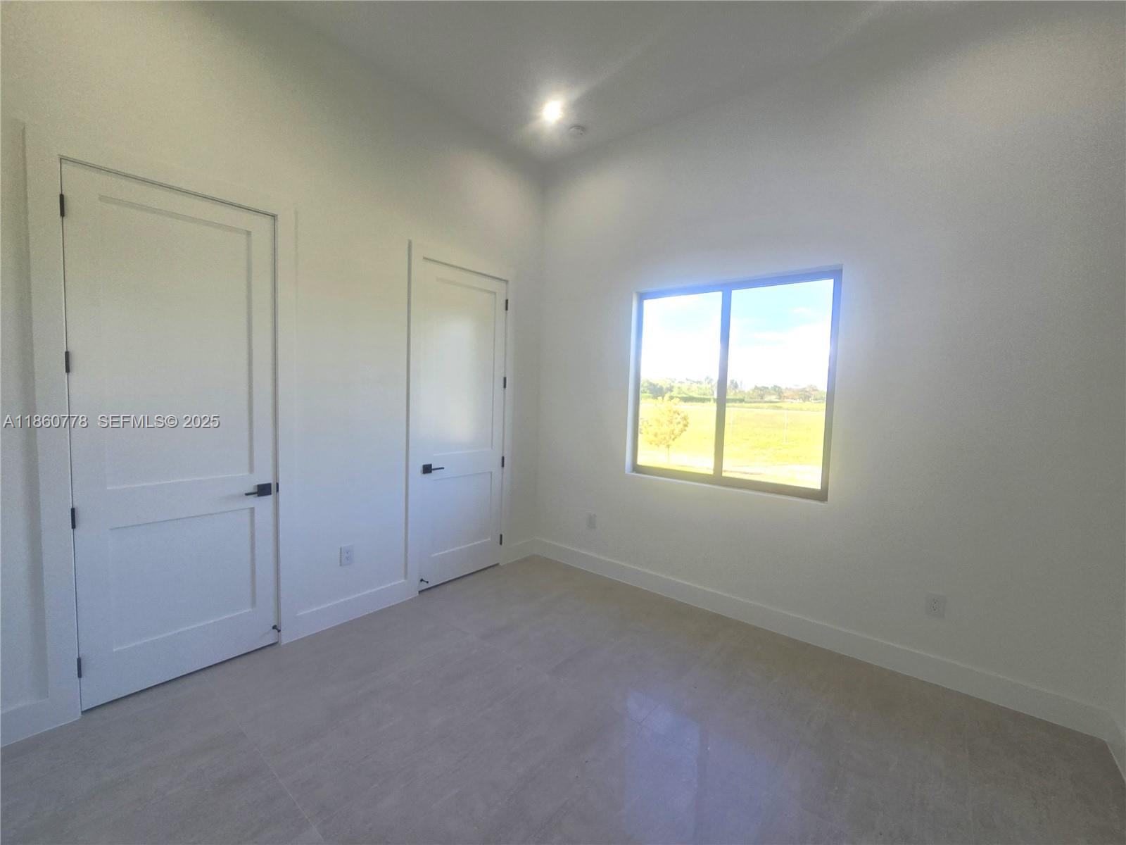 23840 Southwest 209th Place Homestead, FL 33031 - Photo 60 of 89 an empty room with a window