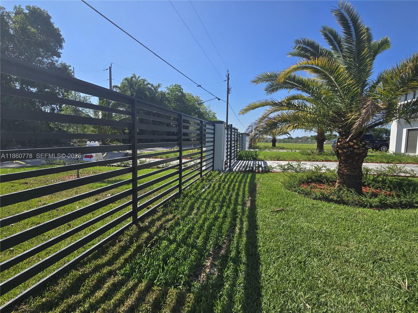 23840 Southwest 209th Place Homestead, FL 33031 - Photo 6 of 89 a view of a yard with plants and a large tree