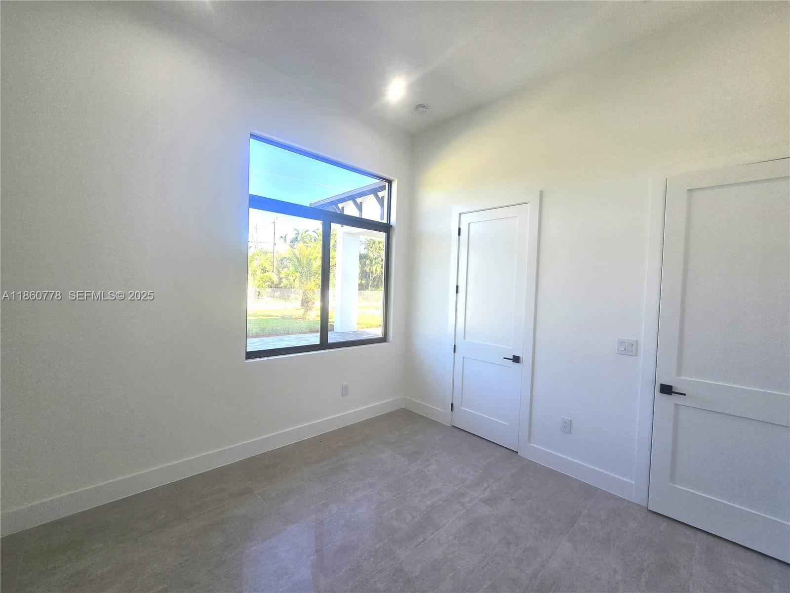 23840 Southwest 209th Place Homestead, FL 33031 - Photo 61 of 89 an empty room with a empty space and windows
