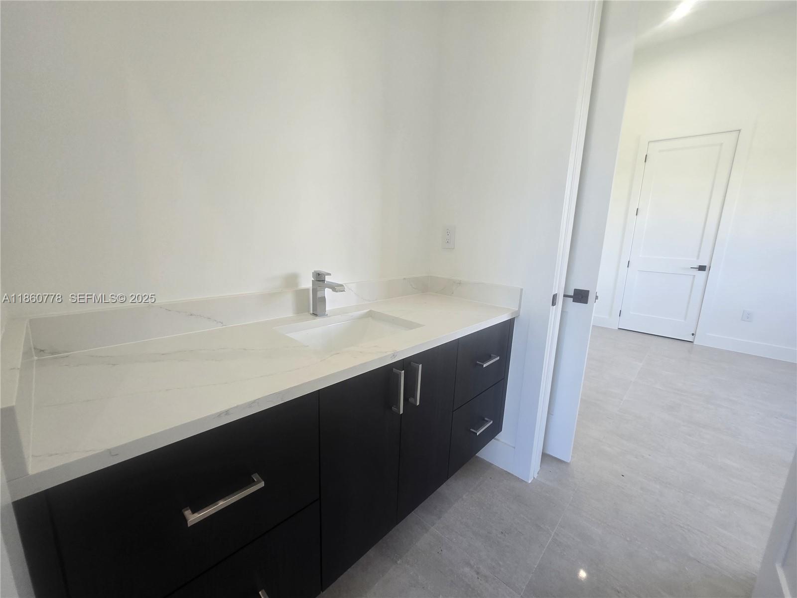 23840 Southwest 209th Place Homestead, FL 33031 - Photo 64 of 89 a kitchen with a sink and a mirror