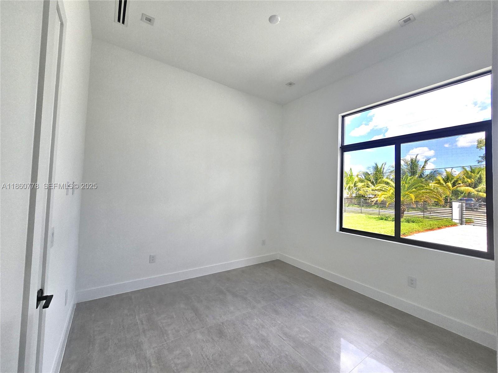 23840 Southwest 209th Place Homestead, FL 33031 - Photo 66 of 89 a view of an empty room with a window
