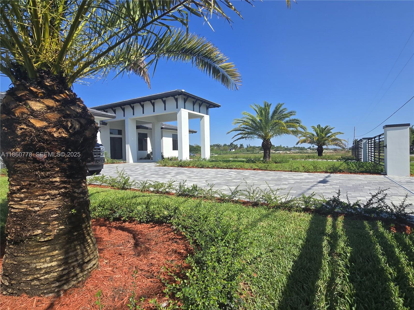 23840 Southwest 209th Place Homestead, FL 33031 - Photo 7 of 89 a front view of a house with a yard
