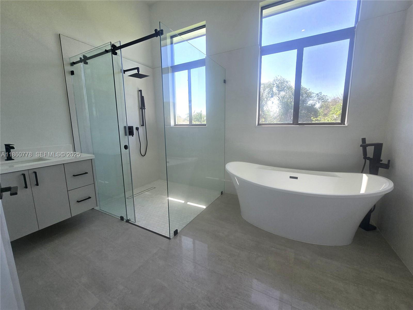 23840 Southwest 209th Place Homestead, FL 33031 - Photo 74 of 89 a spacious bathroom with a bathtub and a shower