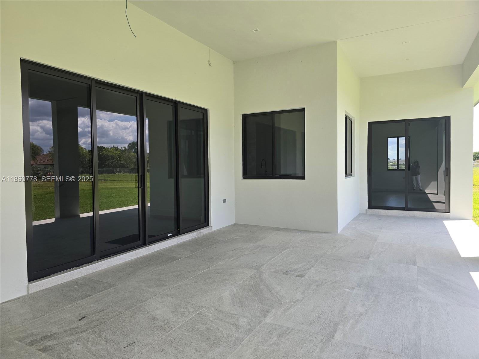 23840 Southwest 209th Place Homestead, FL 33031 - Photo 82 of 89 a view of an empty room with glass door