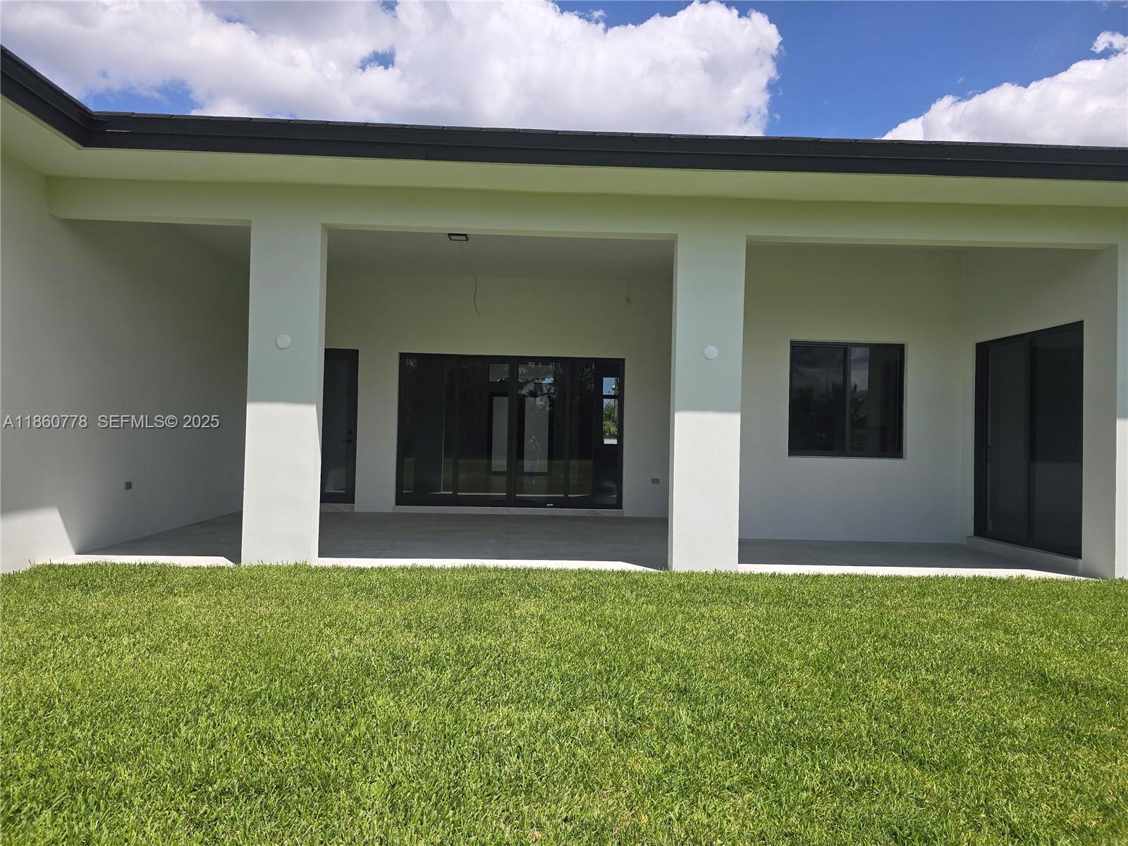 23840 Southwest 209th Place Homestead, FL 33031 - Photo 84 of 89 a front view of a house with a yard