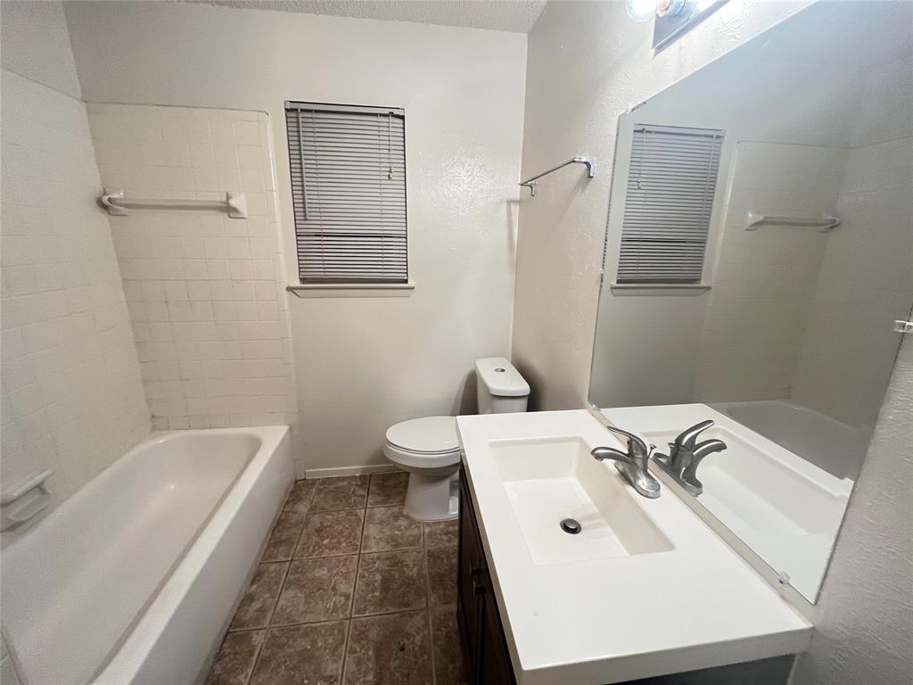 575 Manco Road, Unit A Lewisville, TX 75067 - Photo 5 of 9 a bathroom with a sink toilet and tub