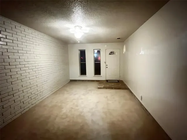 a view of a hallway with front door