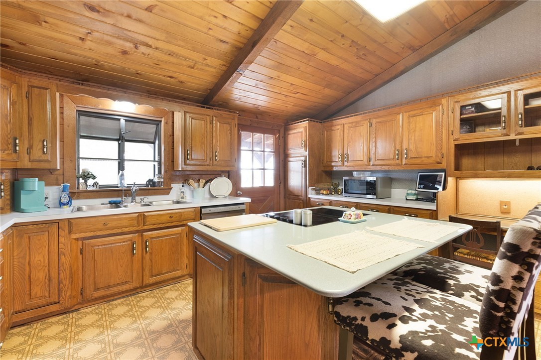 124 Old Mission Road Kempner, TX 76539 - Photo 11 of 39 a kitchen with a sink a stove cabinets and a counter top space