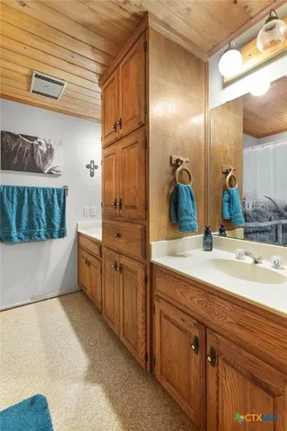 a bathroom with a tub a sink and mirror