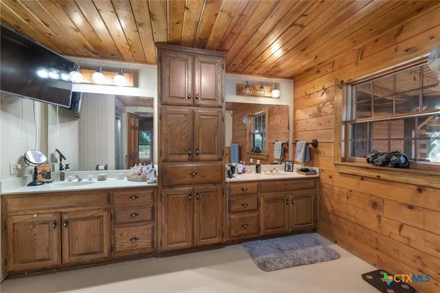 a kitchen with sink and cabinets