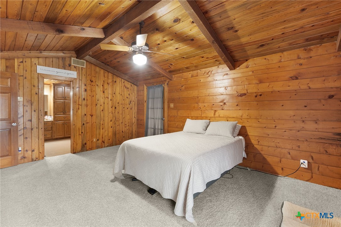 124 Old Mission Road Kempner, TX 76539 - Photo 19 of 39 a bedroom with a bed and a chandelier