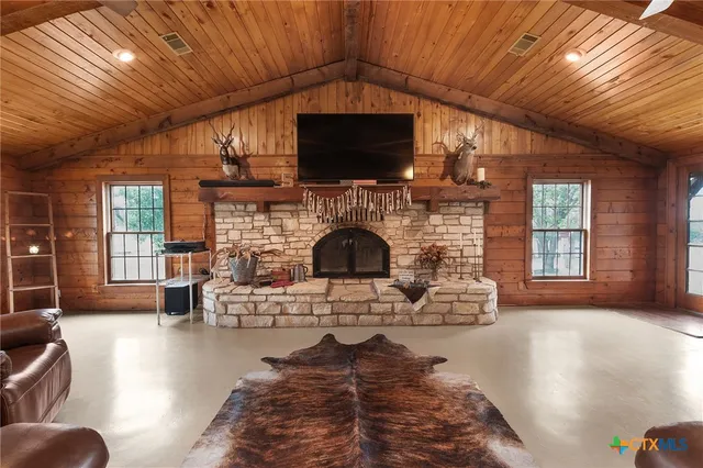 a living room with furniture a fireplace and a flat screen tv