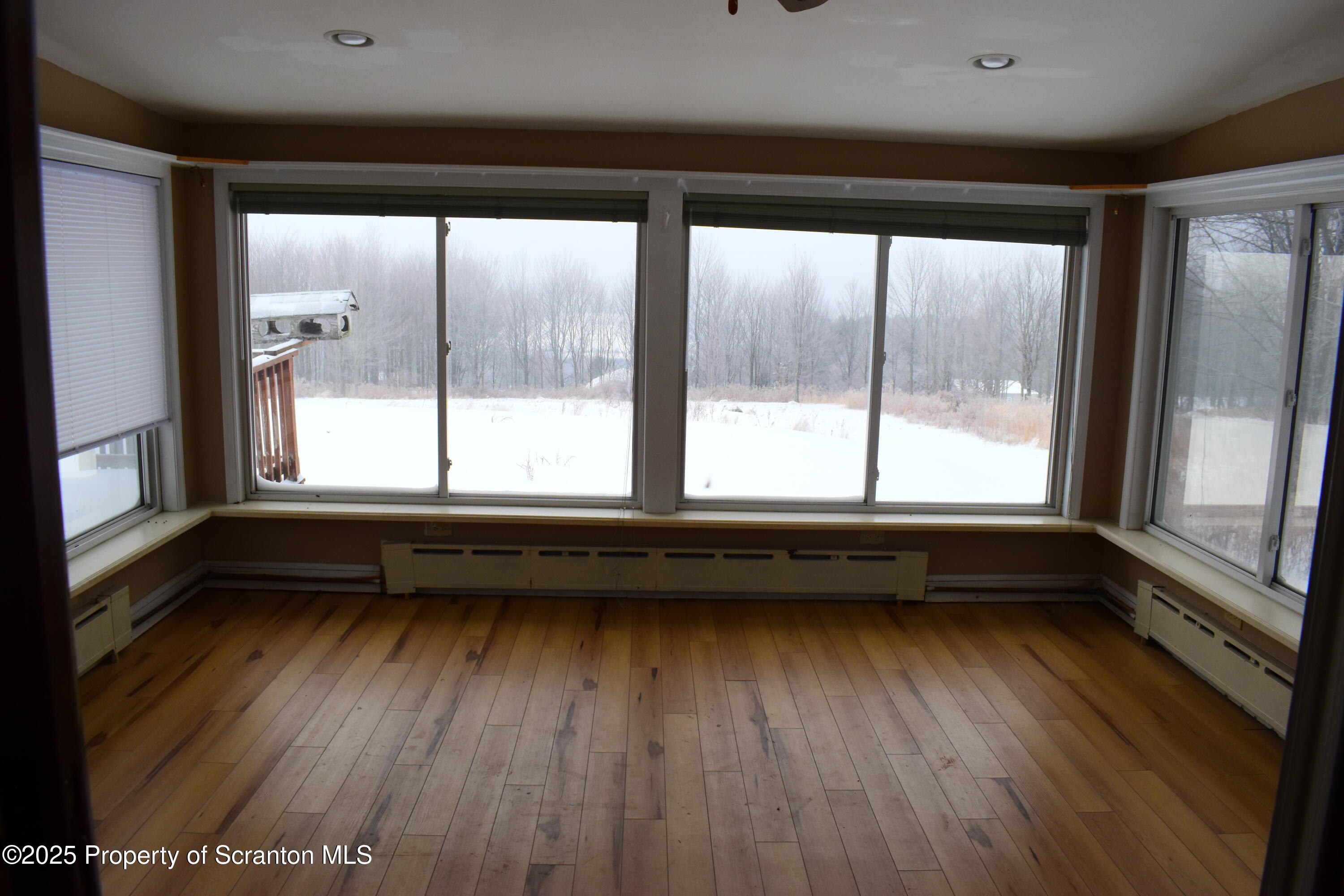 3003 Ridge Road Thompson, PA 18465 - Photo 11 of 33 a view of a room with wooden floor and outdoor space
