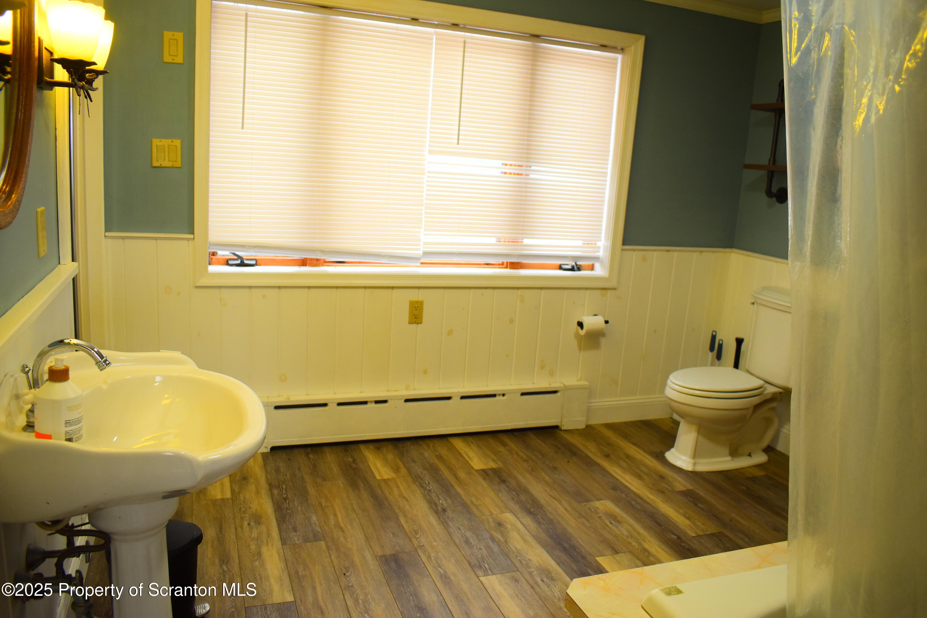 3003 Ridge Road Thompson, PA 18465 - Photo 18 of 33 a bathroom with a sink and a mirror