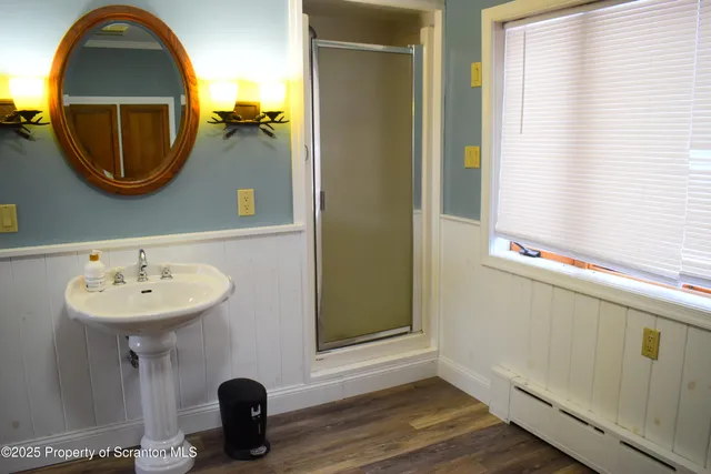 a bathroom with a sink a mirror and a window