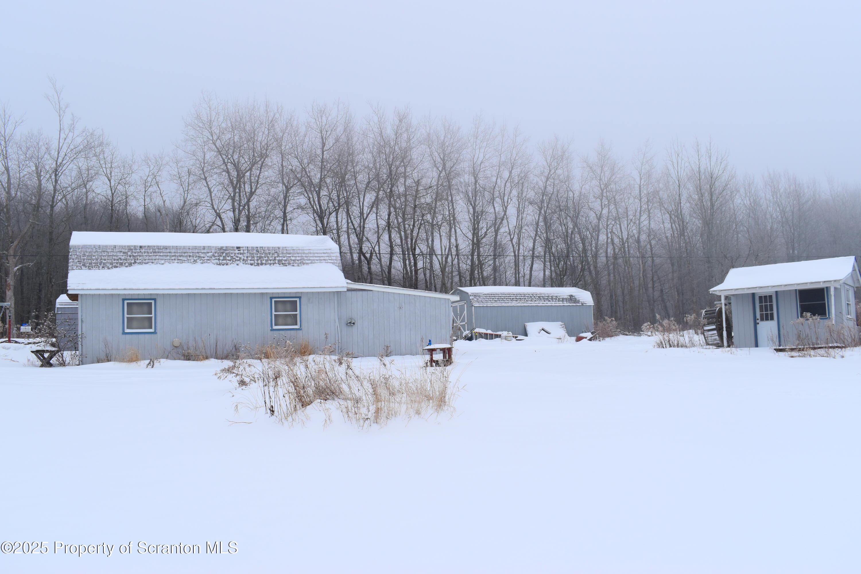 3003 Ridge Road Thompson, PA 18465 - Photo 2 of 33 a bathroom with a sink and a chair