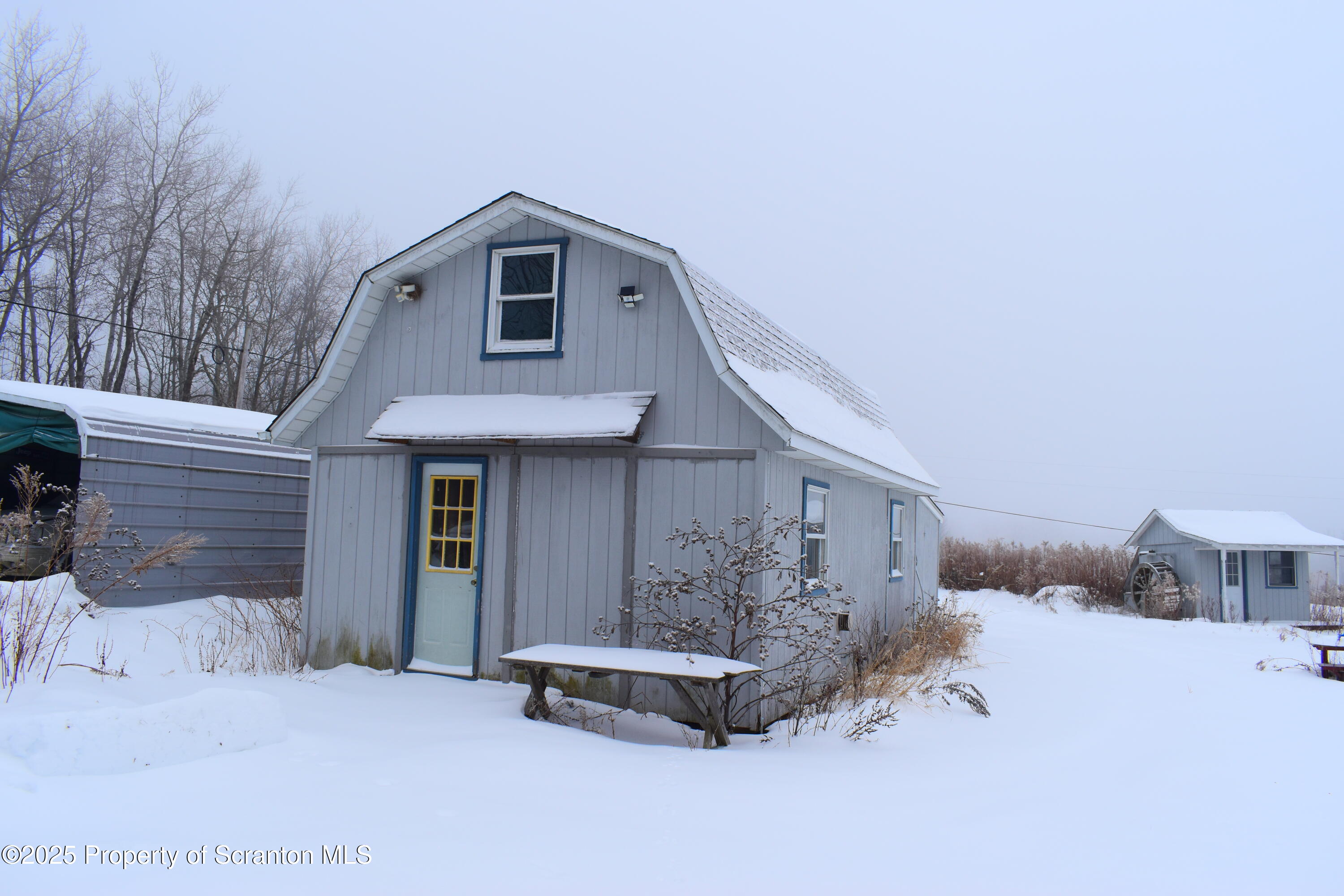 3003 Ridge Road Thompson, PA 18465 - Photo 27 of 33 a front view of a house with a yard