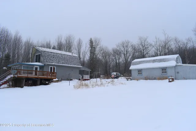 a view of a house with a snow in the yard